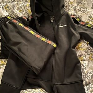 Nike black track suit. Red and green down there sides. Gently used.